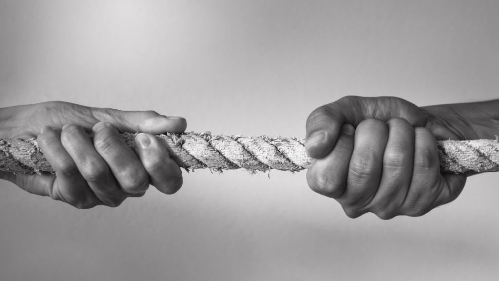 two hands pulling on opposite ends of rope austin asset